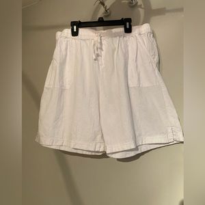 White cotton walking shorts with elastic waist.